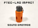 Orange sound grenade with black top on a white background, labeled 'FTEC-LAD Impact'.