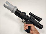 Side view of Brick Blaster with PIN-2 Muzzle installed in hand on white background.