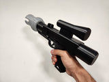 Side view of Brick Blaster with PIN-2 Muzzle installed in hand on white background.