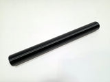 A black cylindrical rod or handle with a smooth, glossy finish, positioned diagonally on a plain white background.