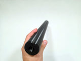 A hand holding a long, black cylindrical plastic rod or stick against a plain white background.